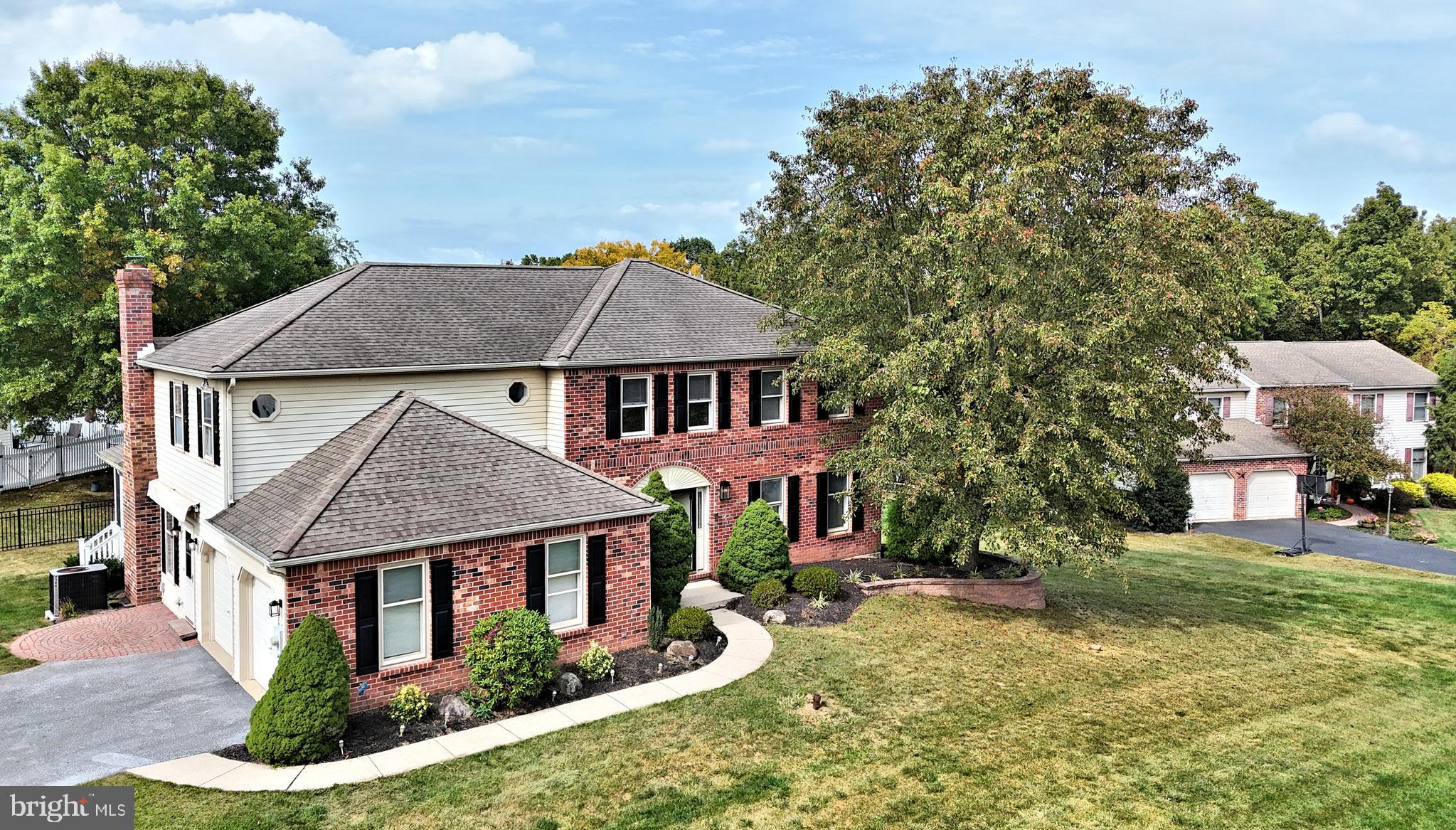 a aerial view of a house with table and chairs under an umbrella