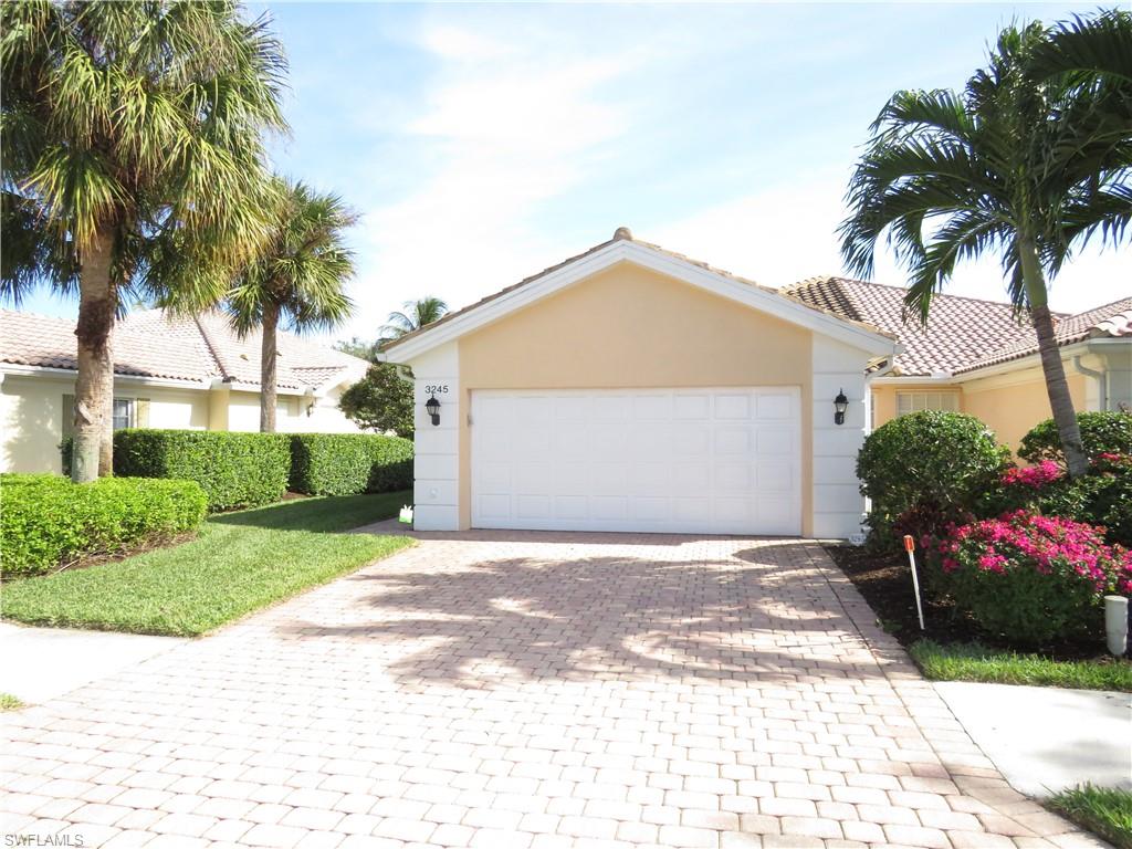 a front view of a house with a yard and a garage