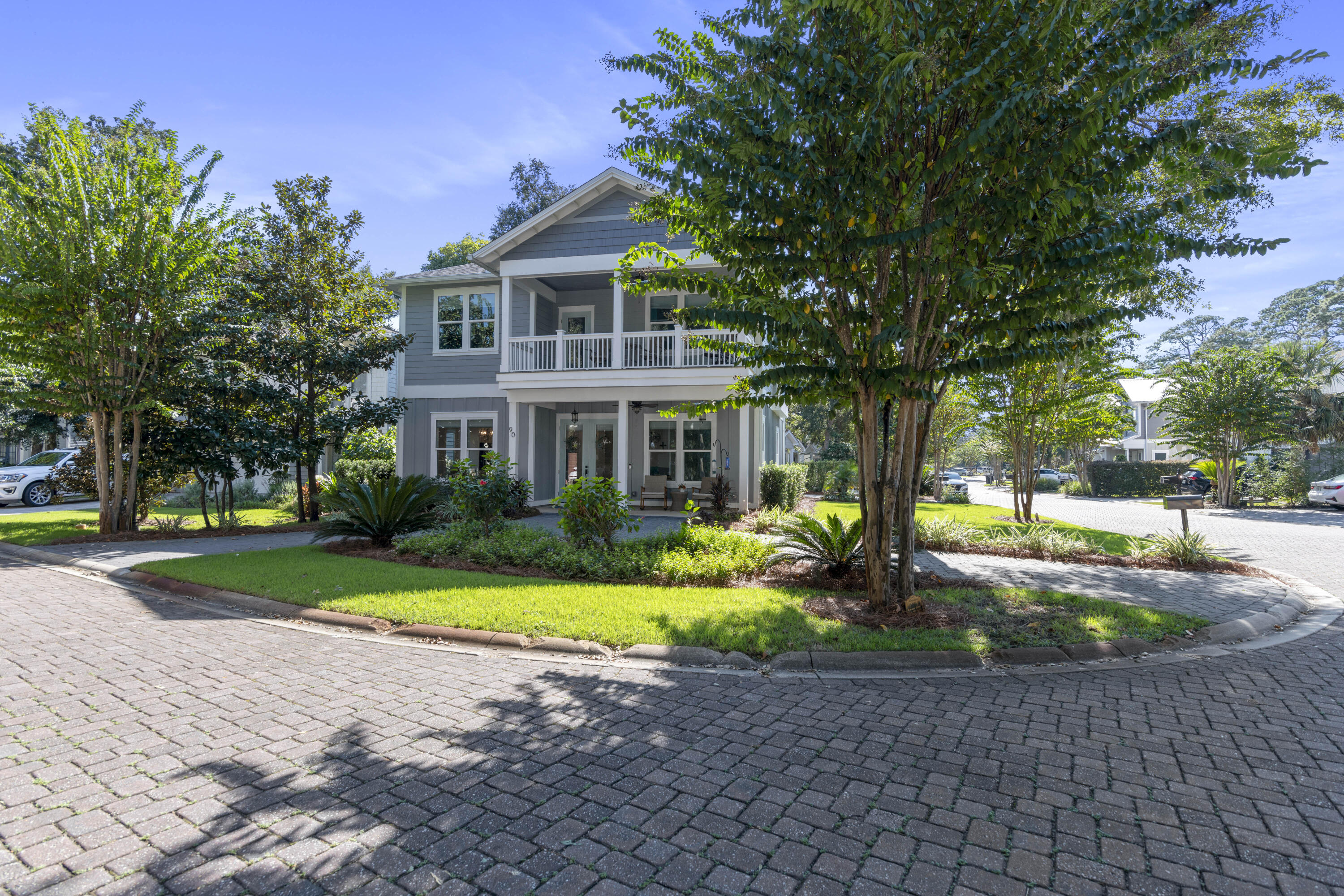 a front view of a house with a yard and garden