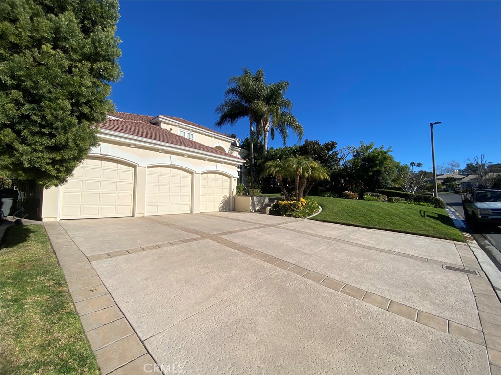 a front view of a house with a yard and a garage