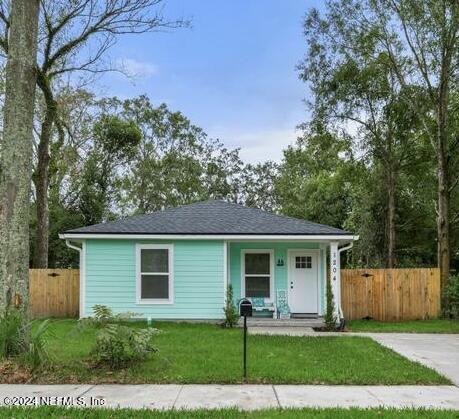 a front view of a house with a yard and porch