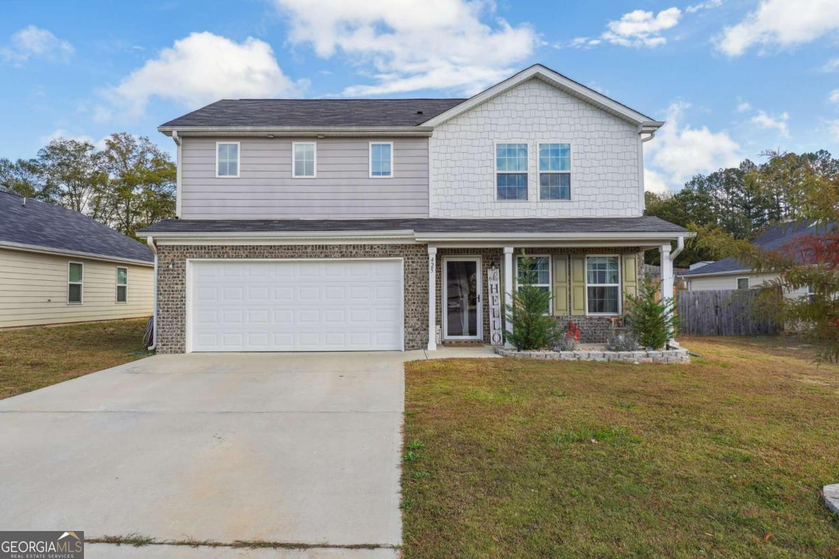 a front view of a house with a yard and garage