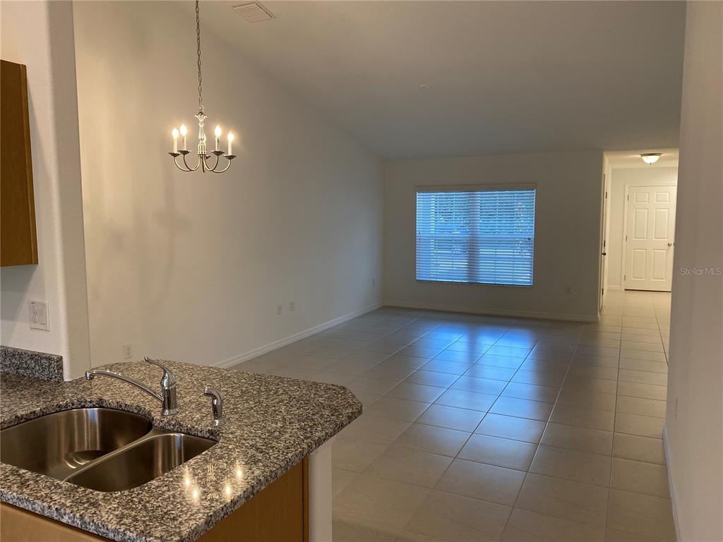 a kitchen with a sink and chandelier