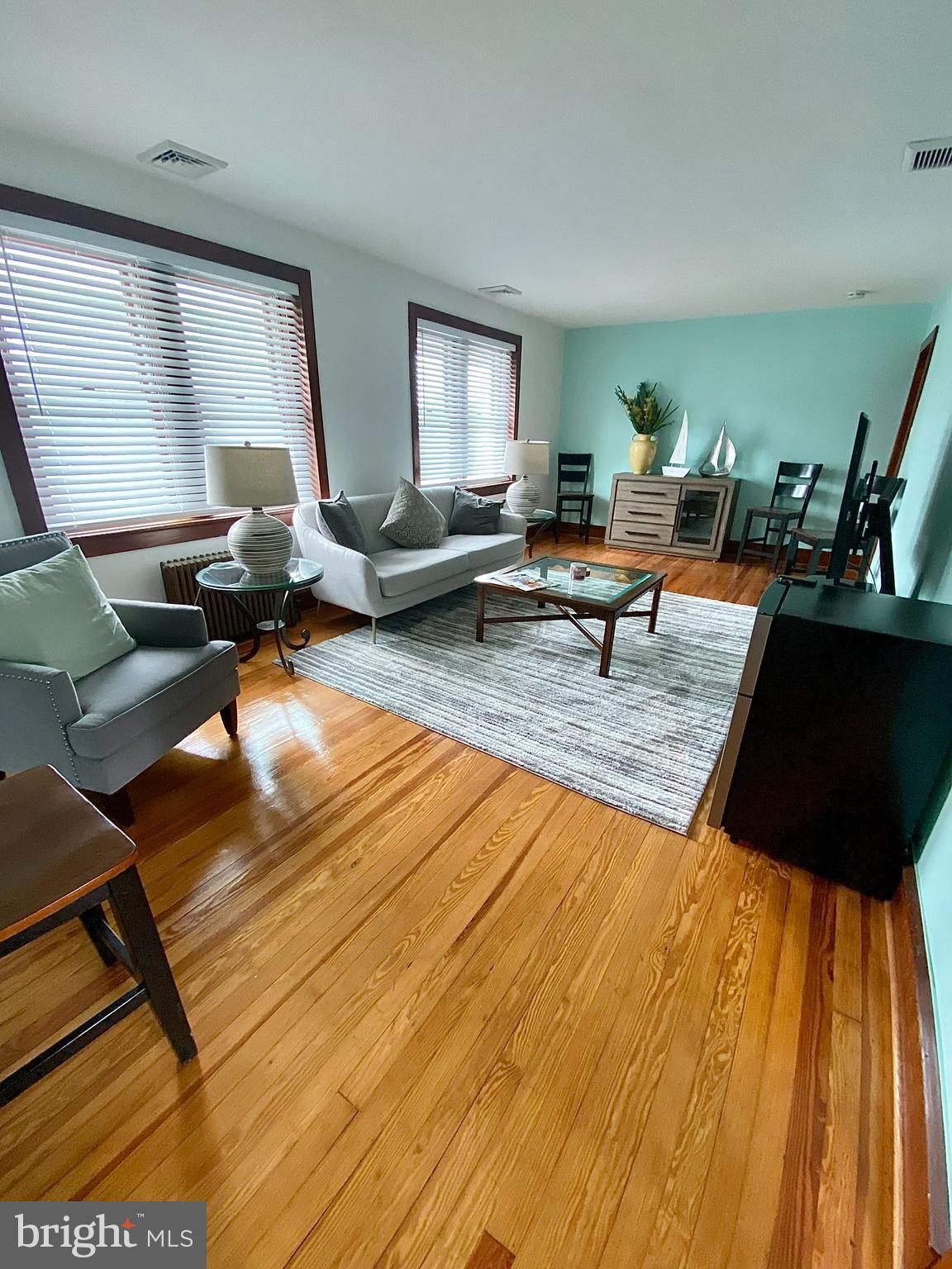 a living room with furniture and a rug