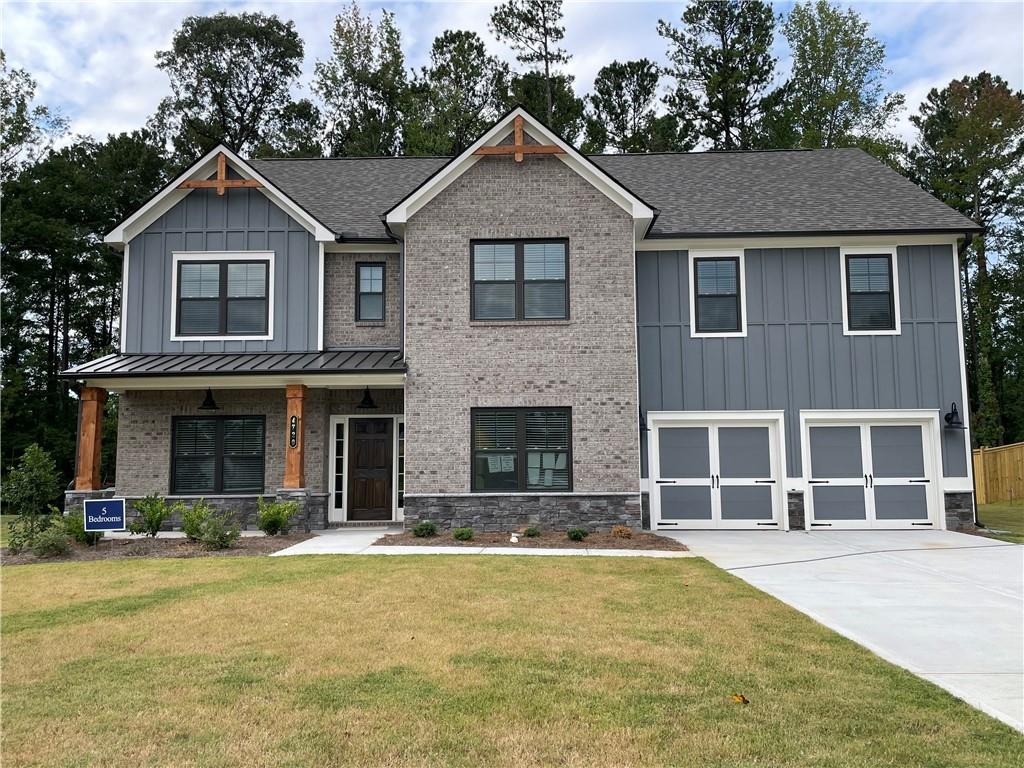 a front view of a house with a yard and garage