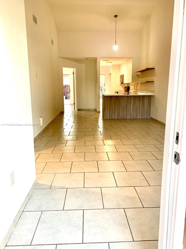 a view of a kitchen with a sink and a window