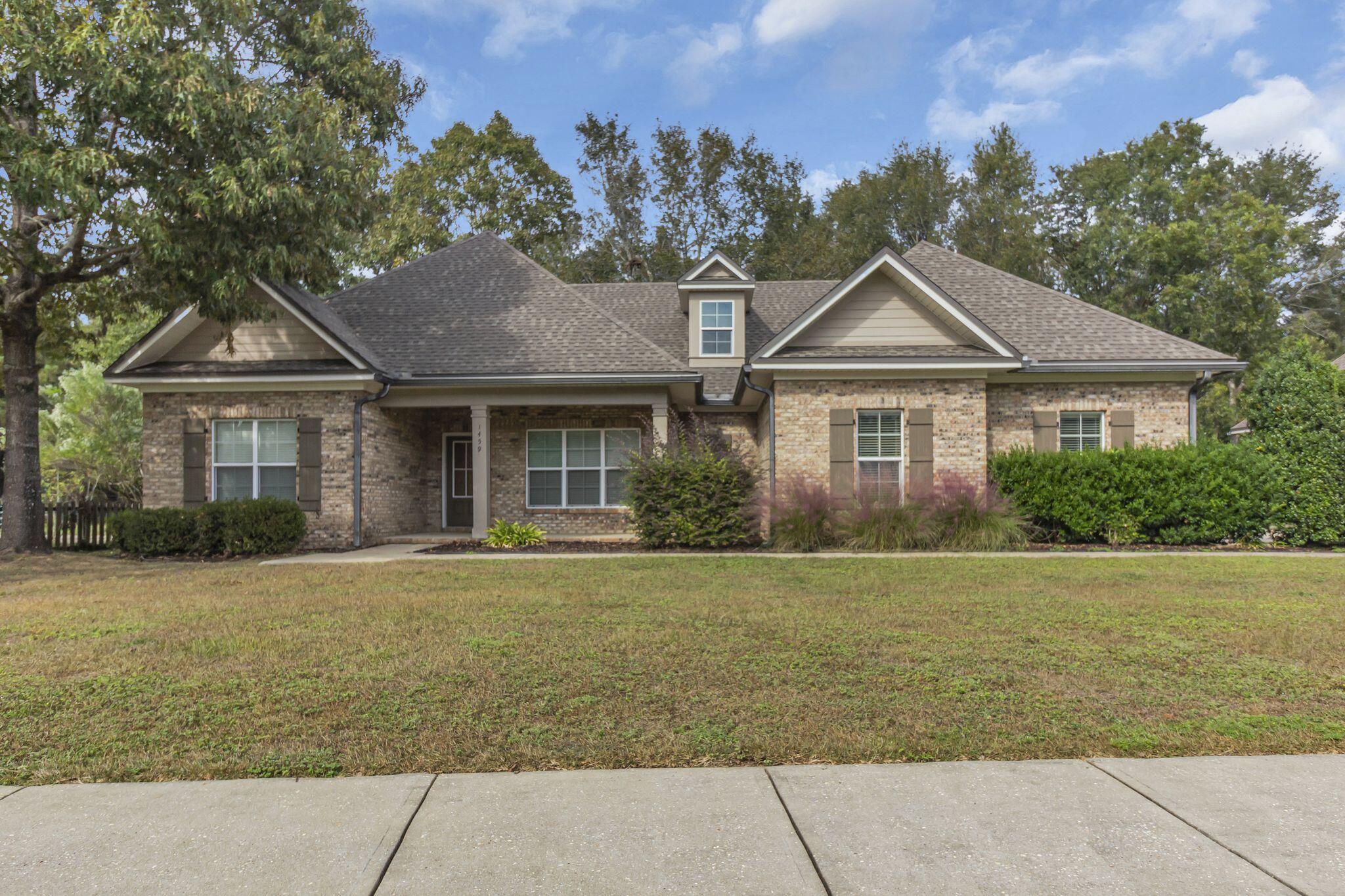 a front view of a house with a garden