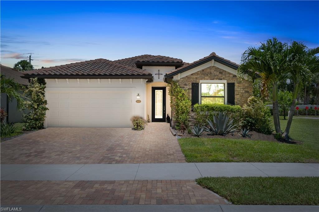 a front view of a house with a yard and garage