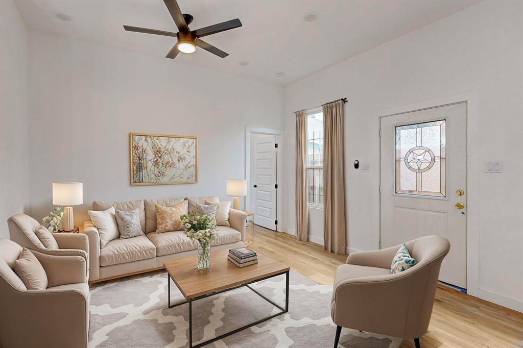 a living room with furniture and a wooden floor