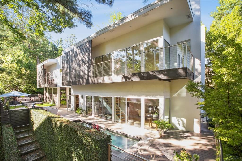 a front view of a house with swimming pool and patio