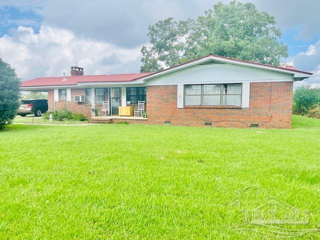 a front view of a house with a garden and yard