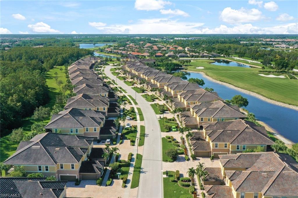 an aerial view of residential houses with outdoor space and swimming pool