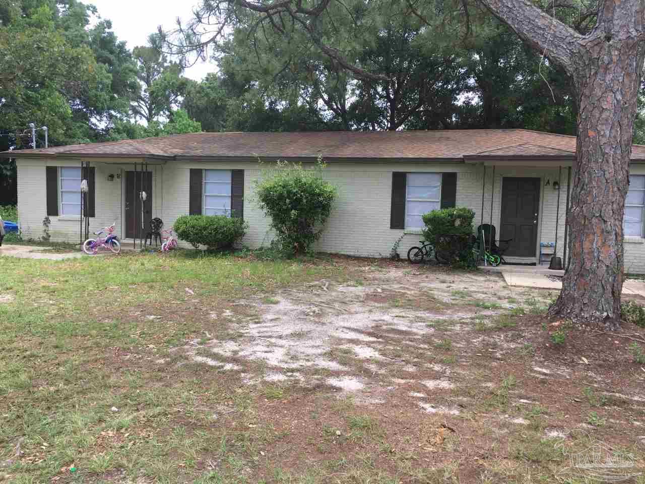 a front view of a house with a yard and porch