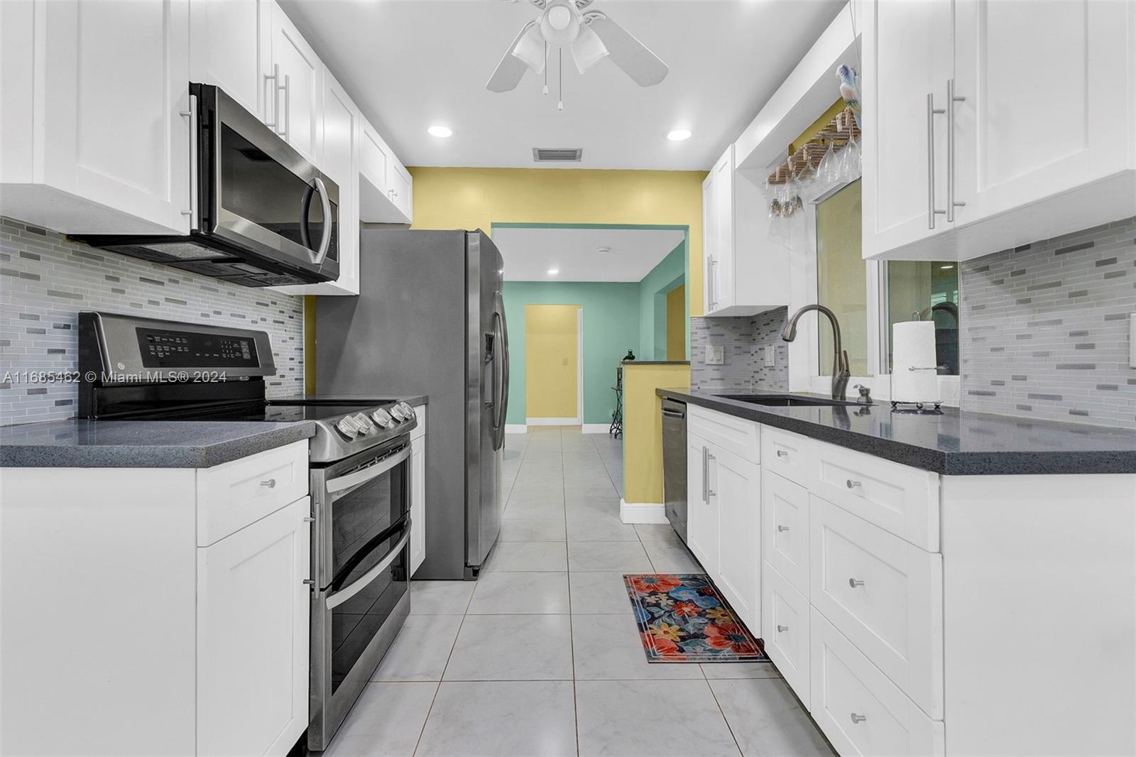 a kitchen with stainless steel appliances granite countertop a sink and a stove