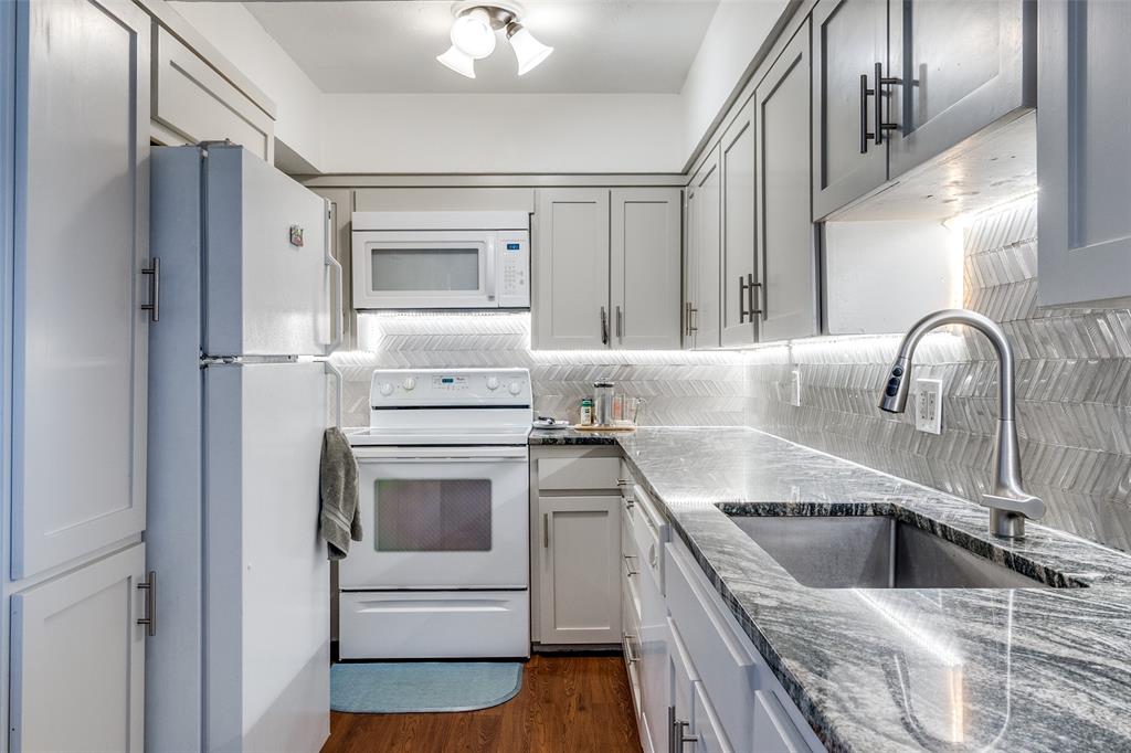 a kitchen with a sink cabinets and stainless steel appliances