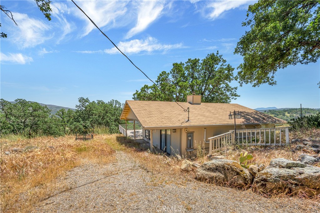 a view of a big house with a big yard and large tree