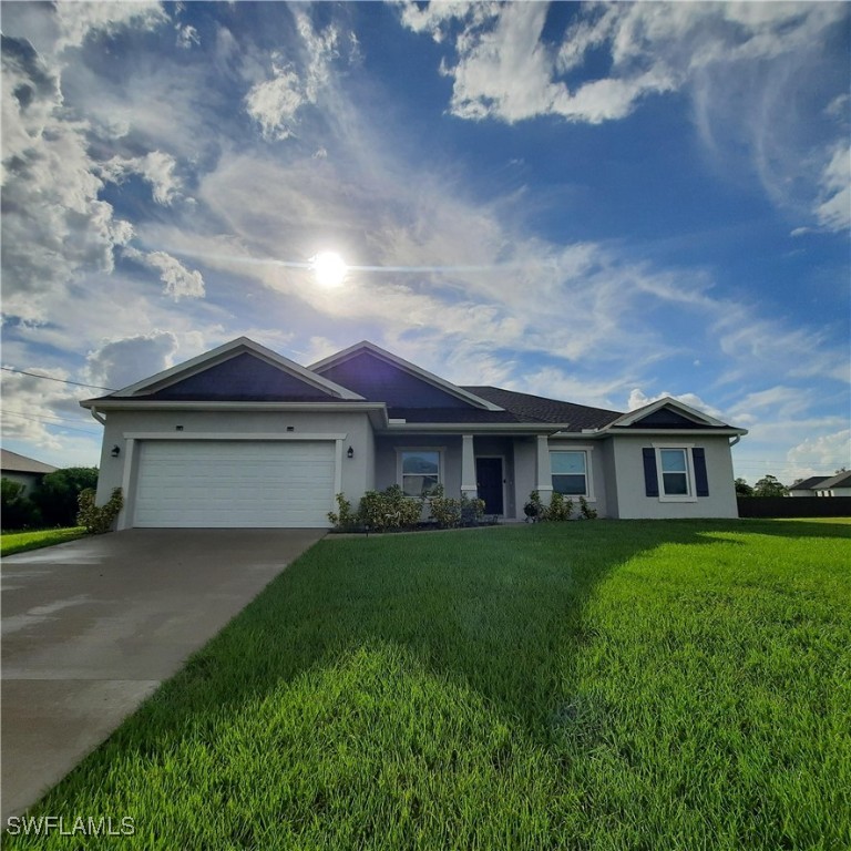 a front view of a house with a yard and garage