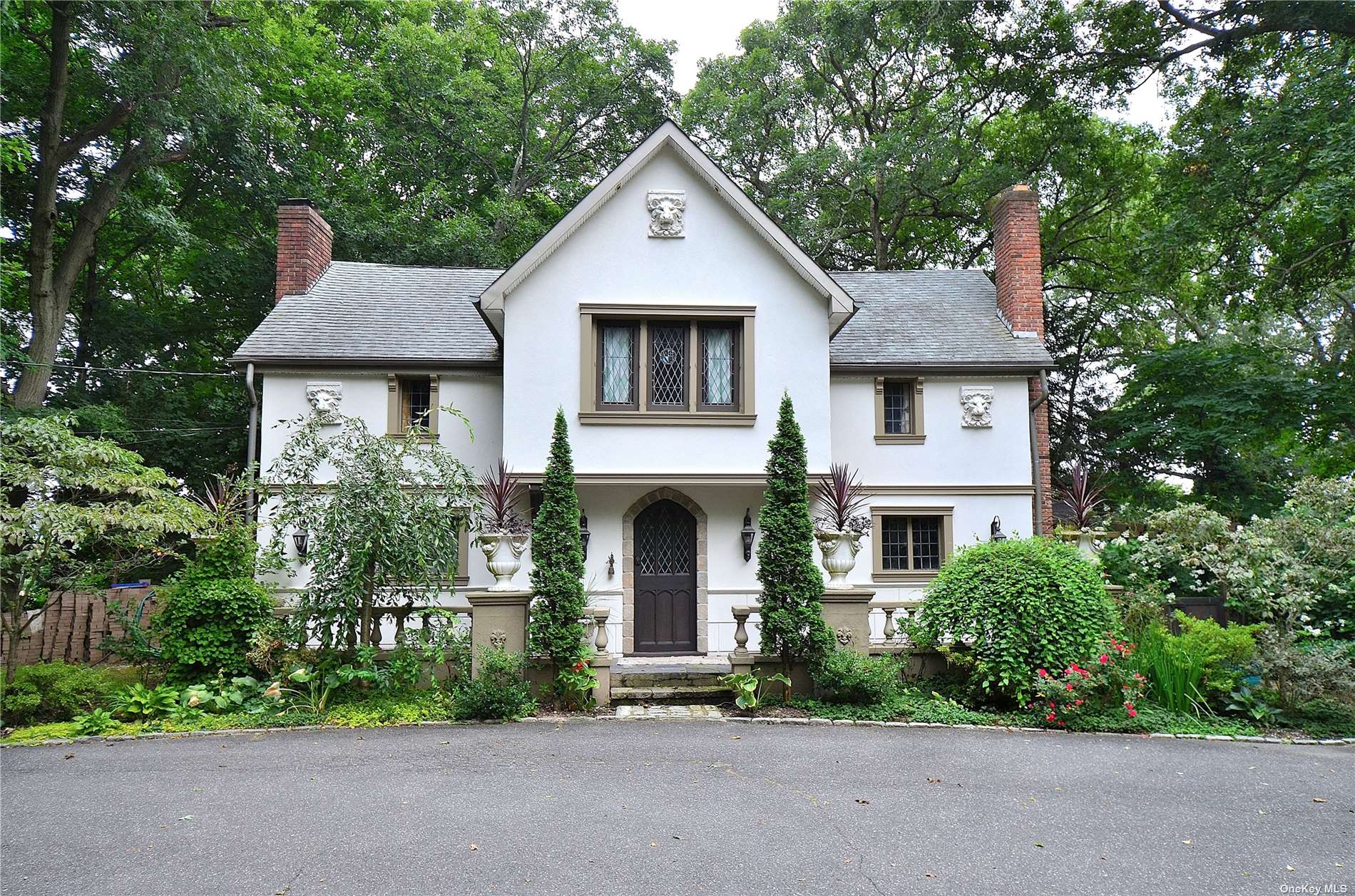 a front view of a house with a garden