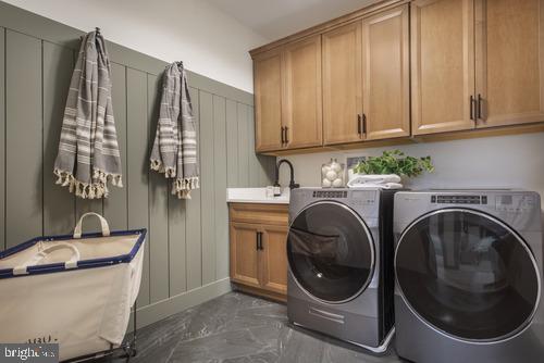 a utility room with sink dryer and washer