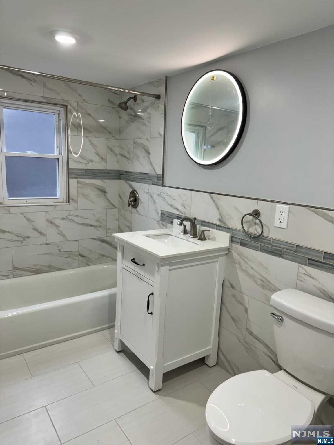 a bathroom with a sink mirror vanity and toilet