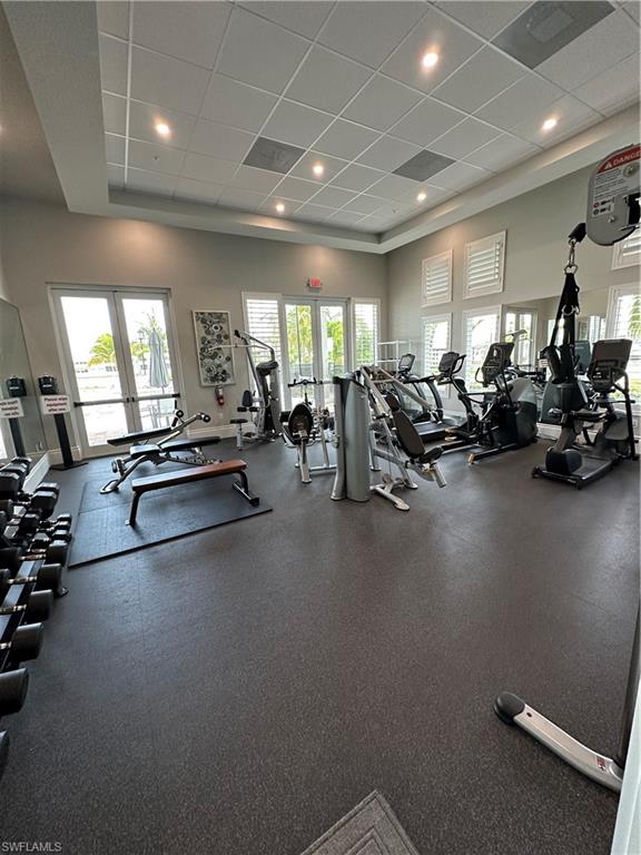 Gym with french doors and a paneled ceiling