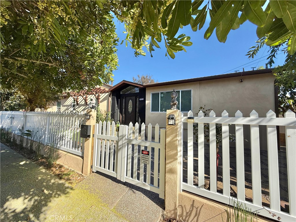 a front view of a house with wooden fence