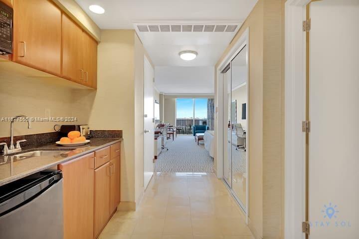 a view of a hallway with a kitchen