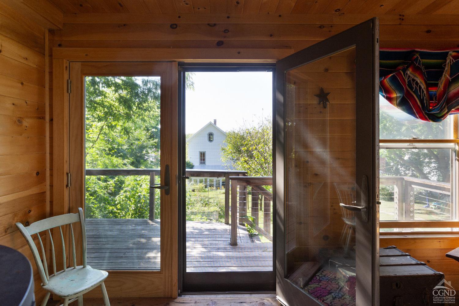 a view of a porch with furniture and wooden floor