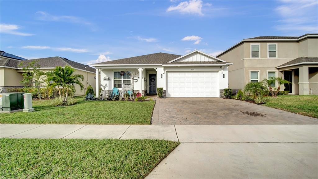 a front view of a house with a yard and garage