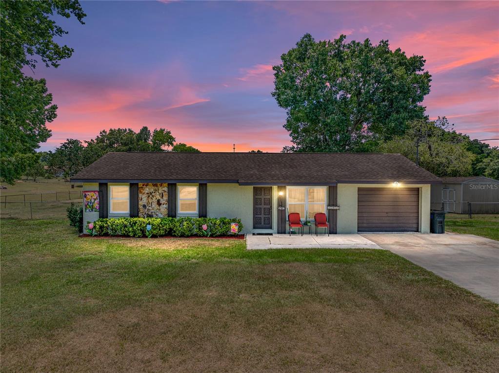 a view of a house with a yard and pathway