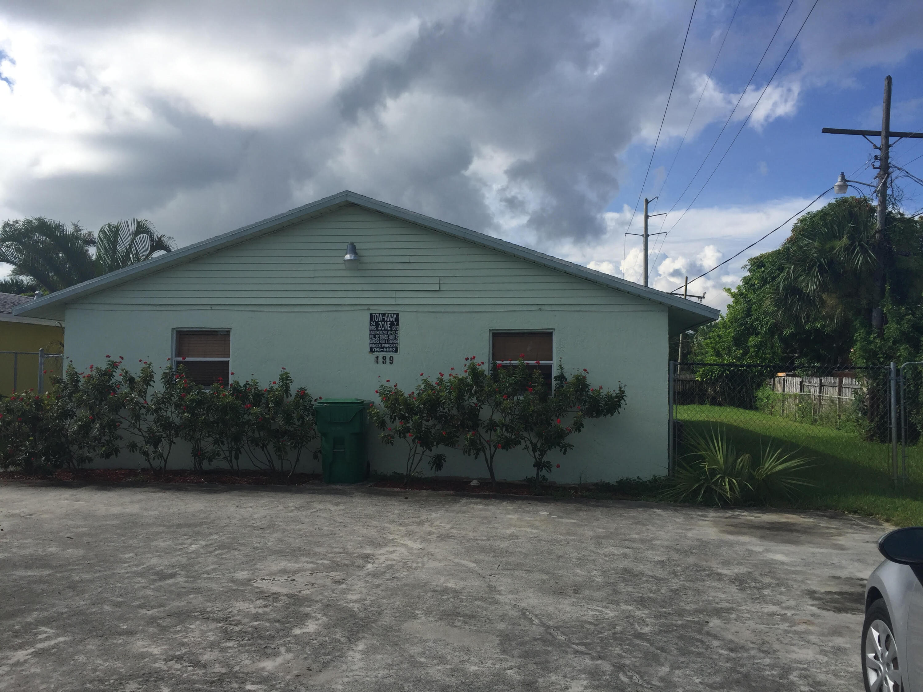 front view of house with potted plants