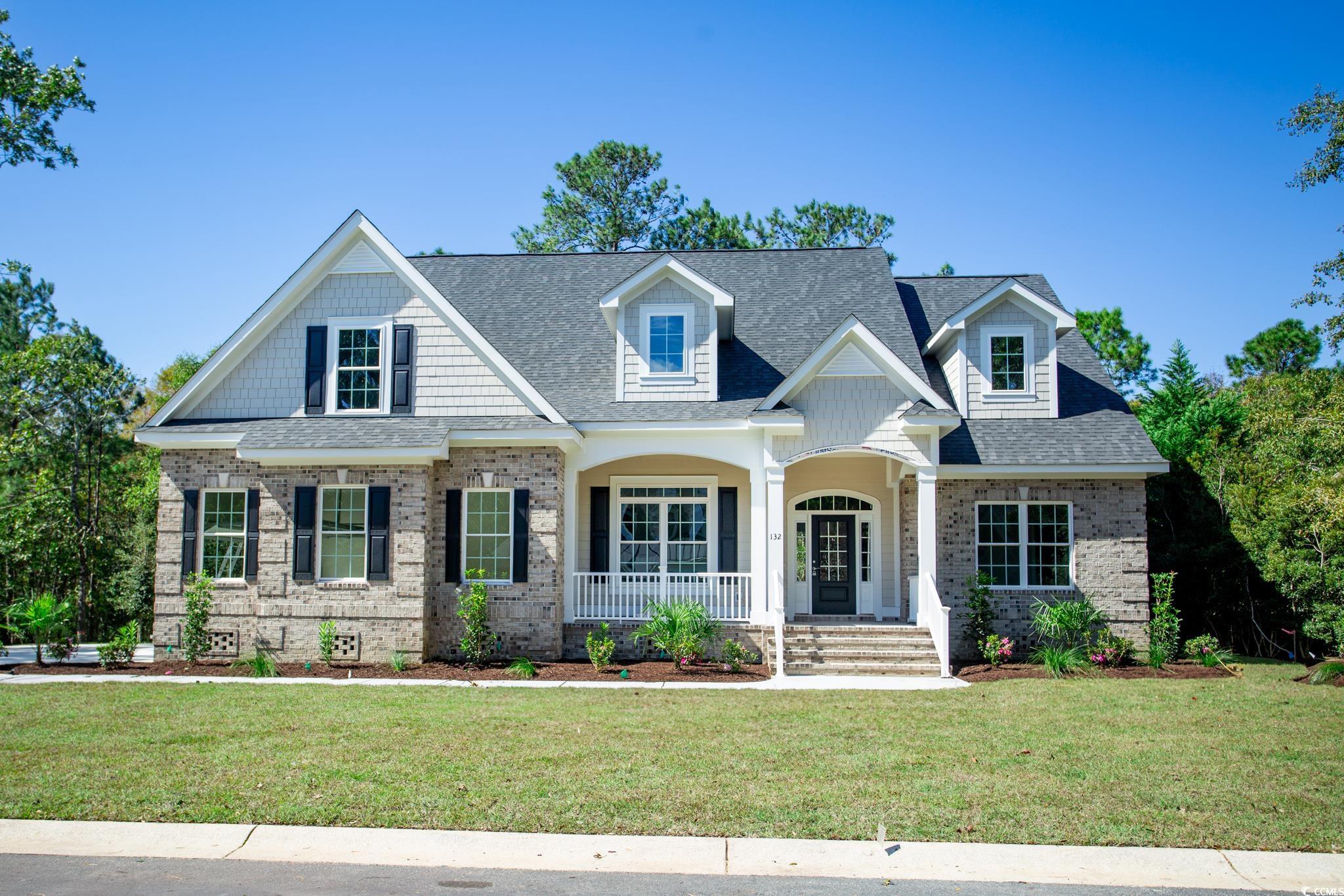 View of front of home with covered porch and a fro