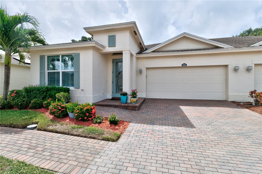 a front view of a house with a yard and a garage