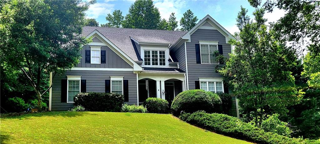 a front view of a house with a yard