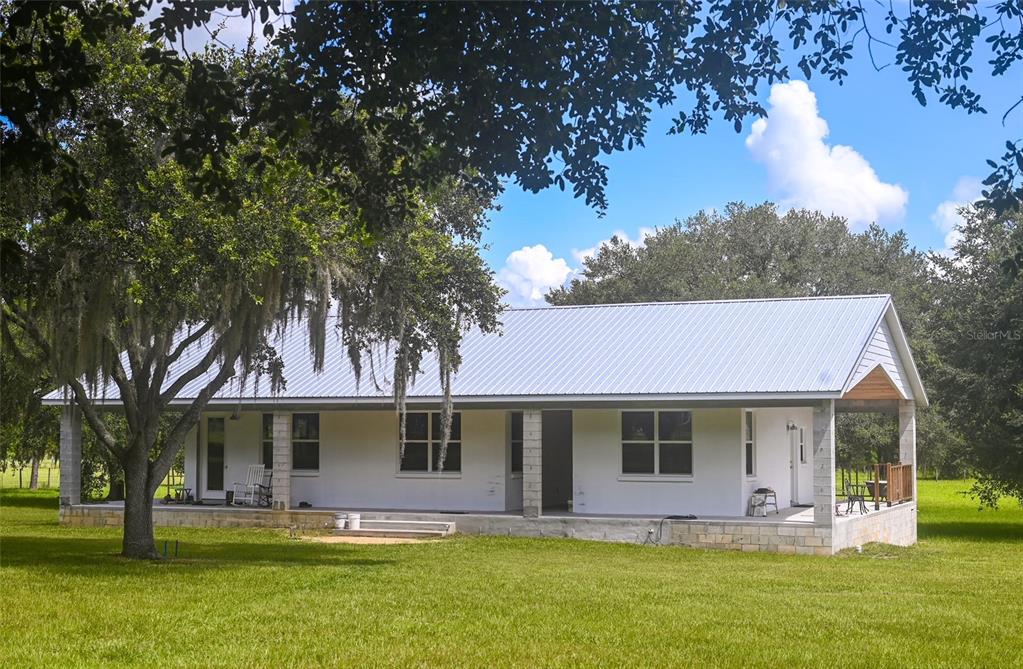 a front view of house with yard space and lake view