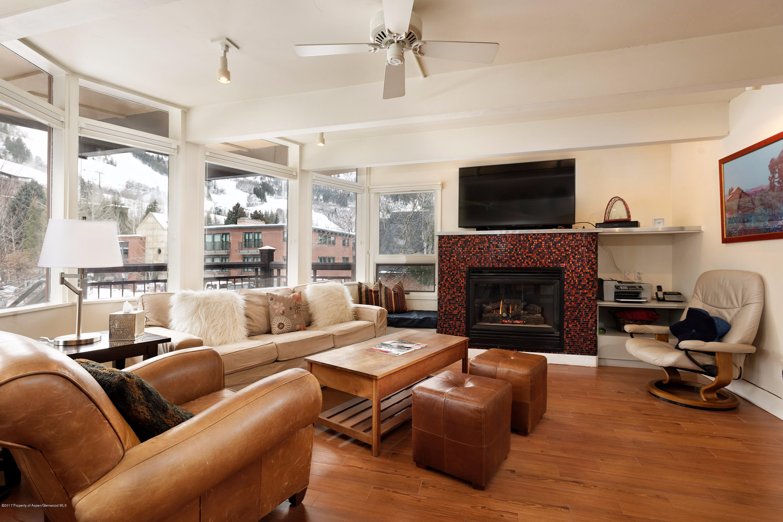 a living room with furniture a flat screen tv and a fireplace