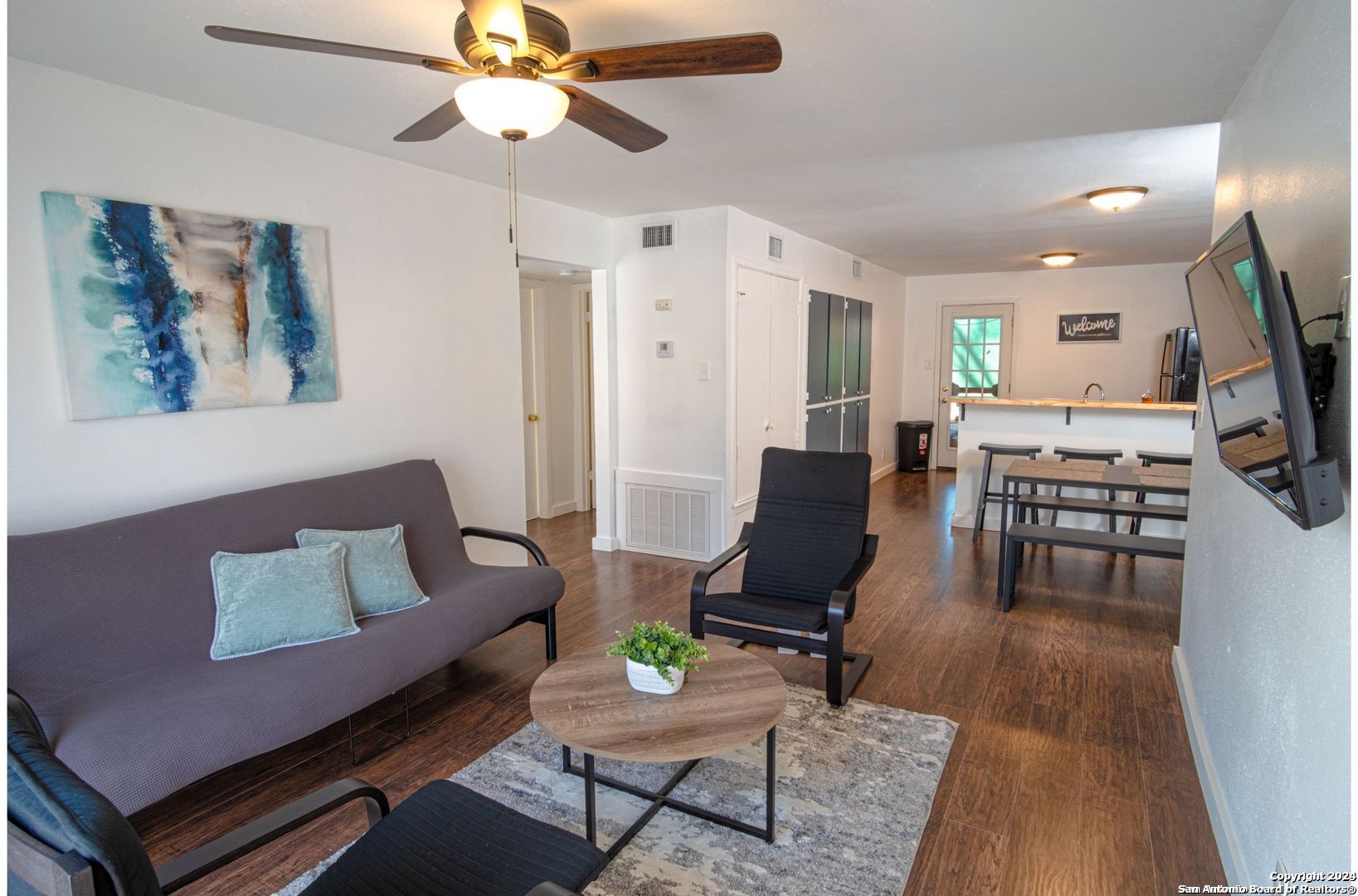 a living room with furniture and a flat screen tv