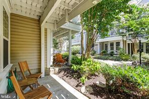 a view of a house with backyard sitting area and garden