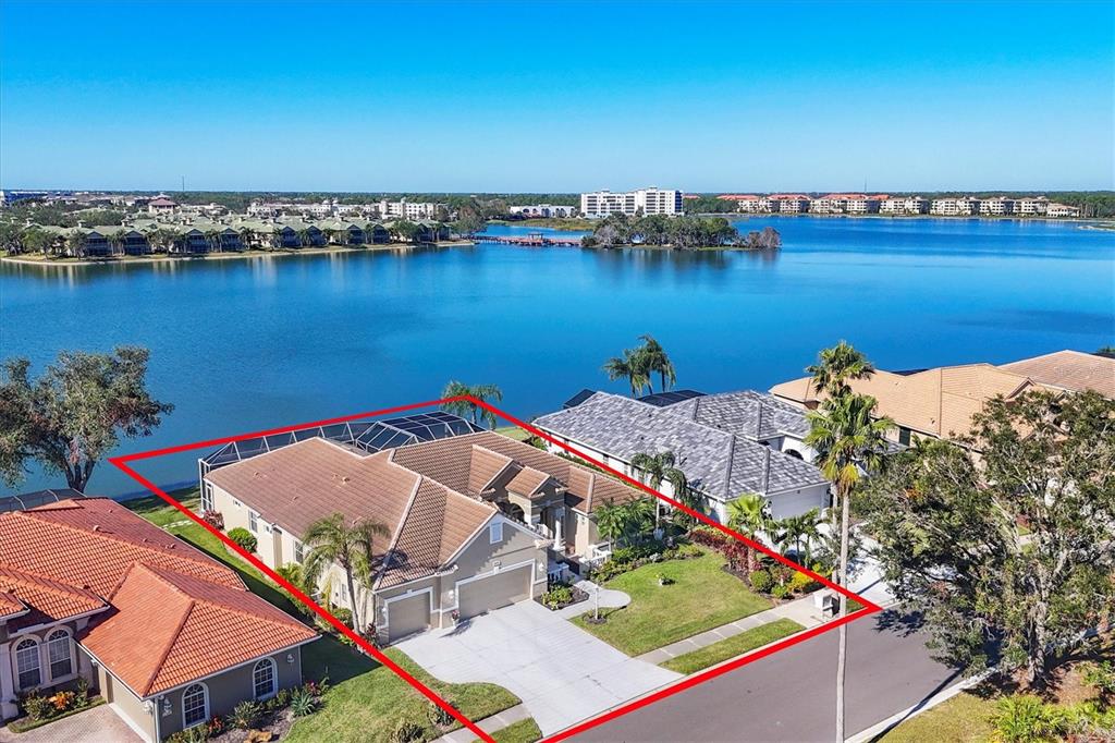 an aerial view of a house with a lake view