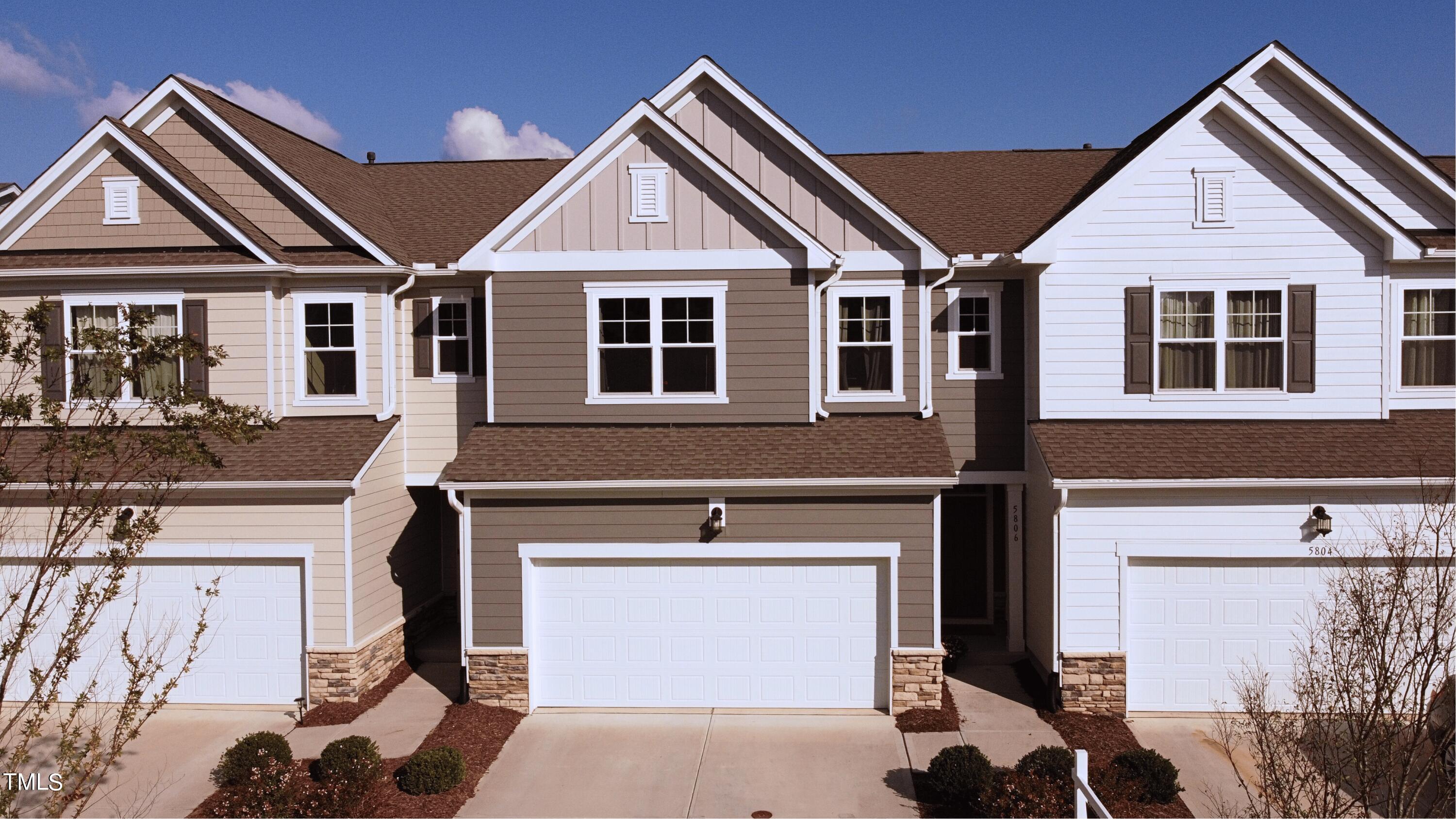 a front view of a house with garage