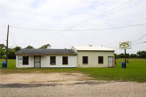 a front view of a house with a garden and garage