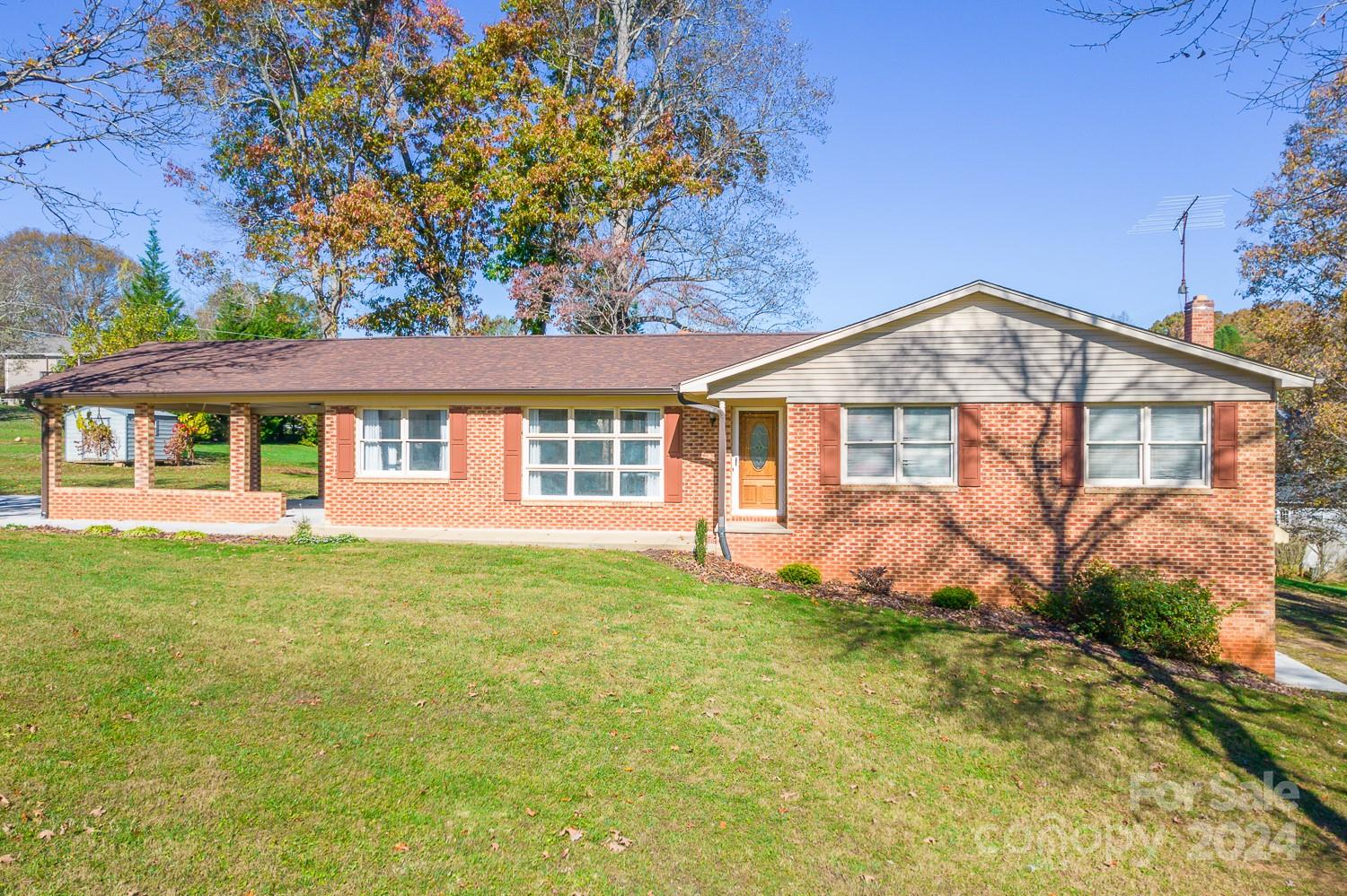 a front view of a house with a yard and porch