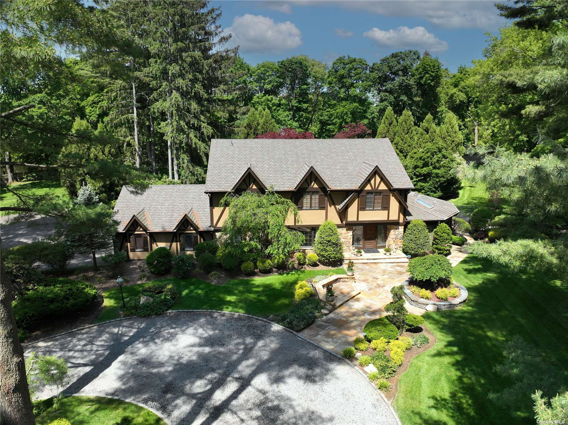 an aerial view of a house with yard and green space