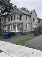 a front view of a house with a yard and a garage