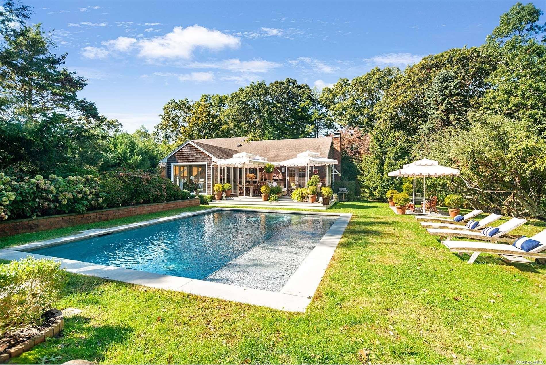 a view of a swimming pool with a yard