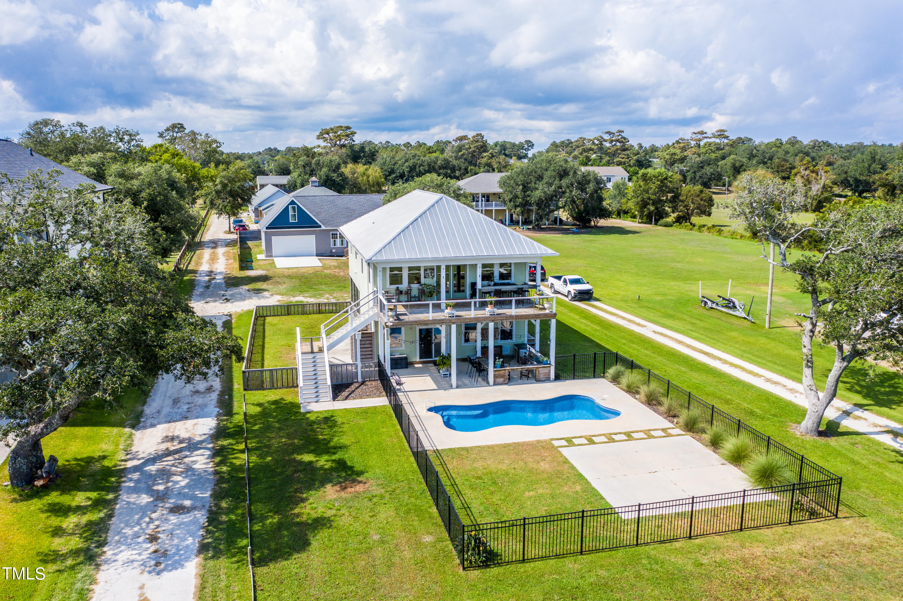 an aerial view of a house with a big yard and large trees