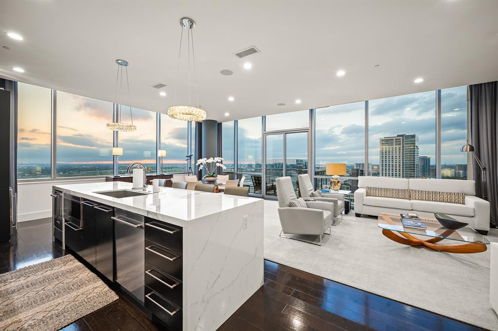 a kitchen with sink attached with living room