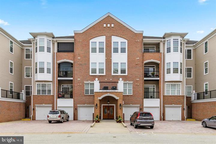 a front view of a residential apartment building with a yard