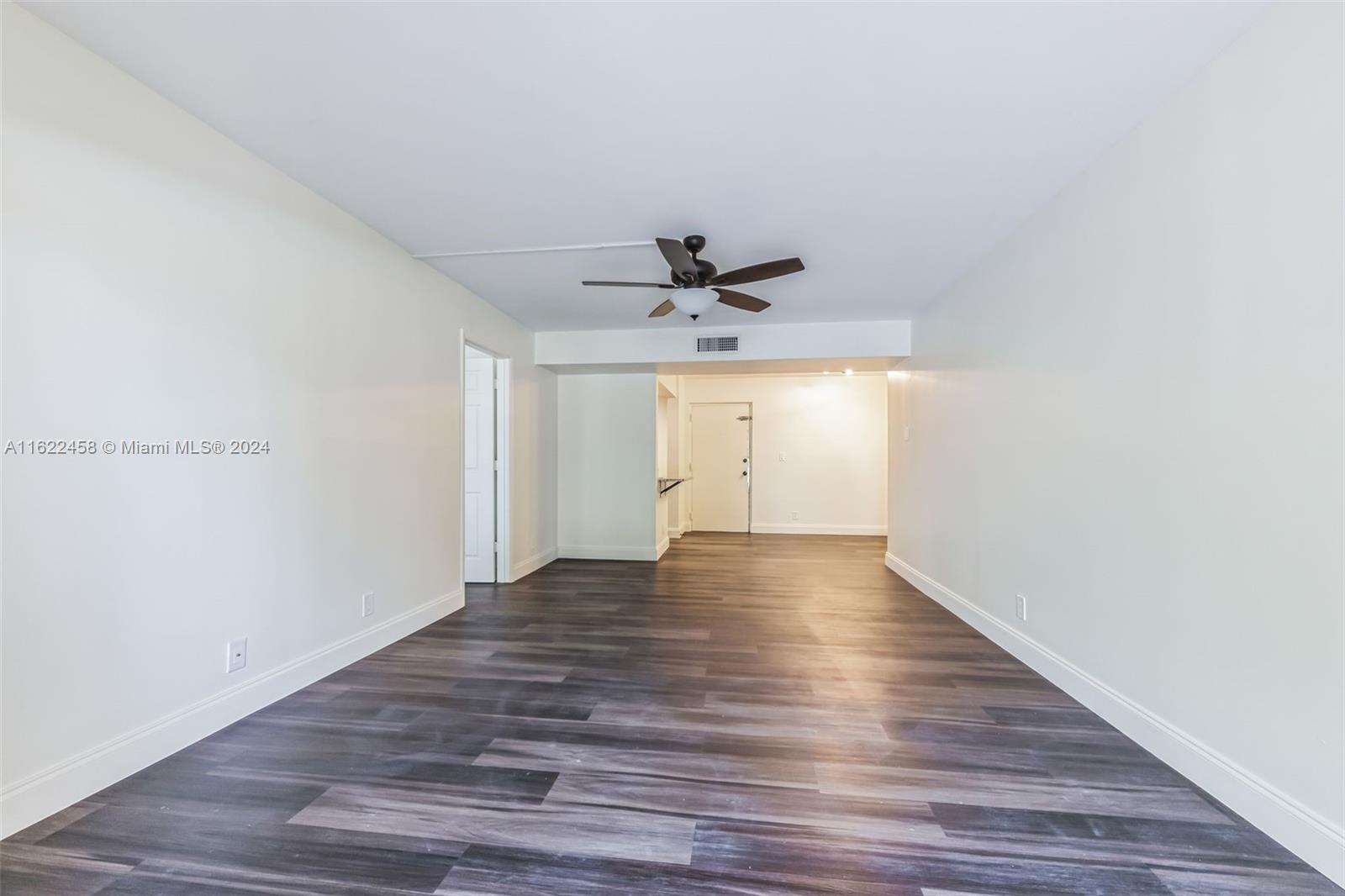 a view of an empty room and wooden floor