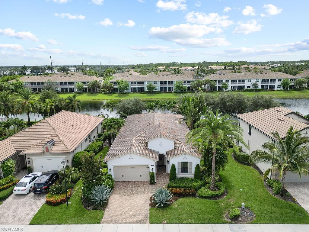 an aerial view of a house with a garden and lake view